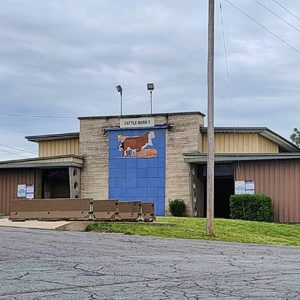 Cattle barn building with metal siding on fairground parking lot