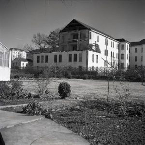 Partly demolished multistory building inside fence