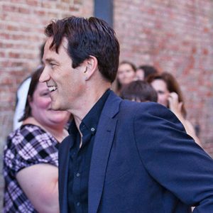 Profile picture of white man in button-up shirt and suit jacket