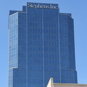 glass and steel skyscraper with "Stephens Inc." at the top