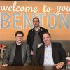 Two white men sitting at table and white man standing in lobby of Kroger store in Benton