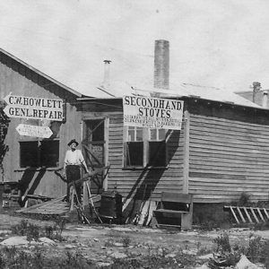 Man standing before various businesses