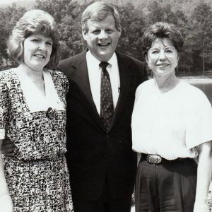 White man in suit and three white women