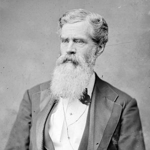 White man with long beard in suit and bow tie