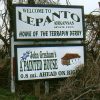 "Welcome to Lepanto Arkansas since 1895 home of the terrapin derby" sign above sign for "John Grisham's A Painted House"