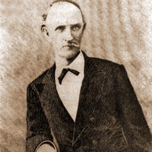 Old white man with mustache in suit and tie