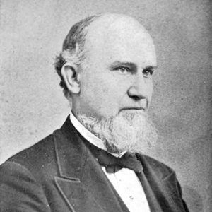 White man with beard in suit and tie