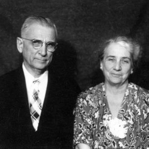 Portrait of smiling white man and woman in formal attire.