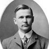 Portrait of white man with mustache and three-piece suit hand-signed "Chas L Thompson"