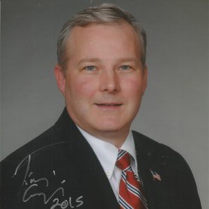 White man smiling in suit and tie signed "Tim Griffin 2015"