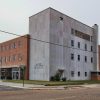 Multistory brick and concrete building on street corner