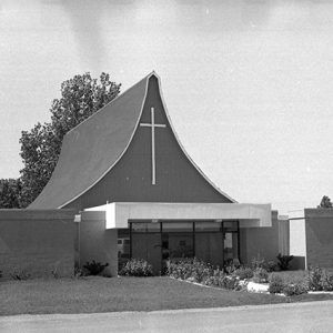 Single-story building with cross on tented roof