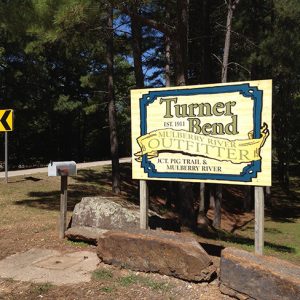 "Turner Bend" sign with rock barriers and mail box and road sign