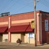 Red brick storefront building on street corner