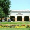 Single-story building with arched entrances and parking lot