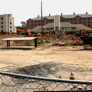 Construction site with fence and tall buildings in the background