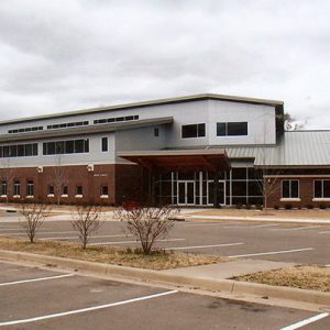 Multistory brick building with parking lot