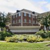 brick sign reading "University of Central Arkansas" in front of three-story brick building