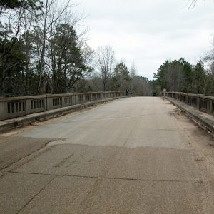 Looking across concrete bridge with railing