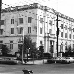 Four story building with street and parked cars