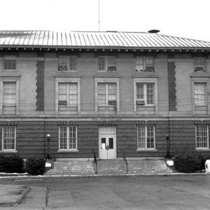 Three-story building with steps and parking lot