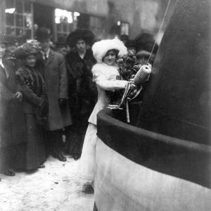 White woman hitting ship with bottle