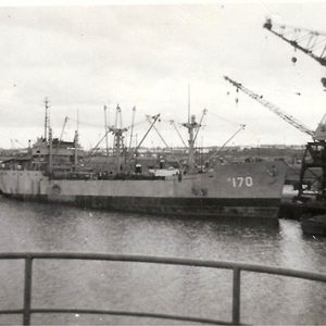 Port with Naval vessel number 170 at dock with cranes taken from another vessel across from it