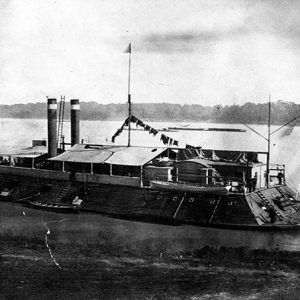 Naval steamboat on river tied to shore