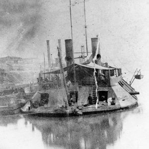 Close-up view of naval steamboat on river with sailors on deck