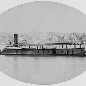 oval-shaped photo of the Side view of naval steamboat on river