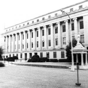 Large multistory classical building with columns clerestory soldier on gazebo monument