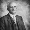 Older white man in suit jacket vest and tie