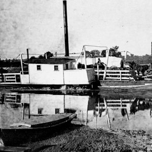 Horse drawn wagons on ferry boat on river