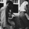 African-American students with books and a sack lunch at school