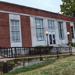 Brick post office building with wheelchair ramp and railing