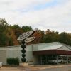 Single-story building with drive-through entrance and sign reading "Tower of Strength Ministries"