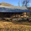 Log cabin with covered porch on grass