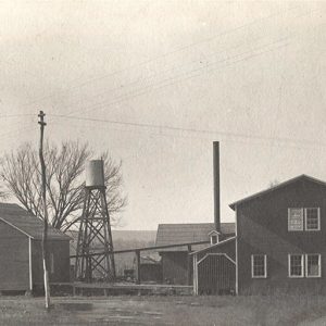 Two buildings with water tower between them