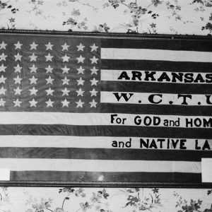 Framed American flag with "Arkansas W.C.T.U. for God and Home and Native Land" written on its white stripes