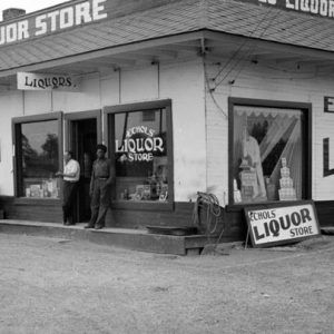 "Echols' Liquor store" on street with a white man and black man standing outside