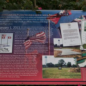 "The Arkansas flag Webbaseka Memorial" interpretation panel with photographs on it and text