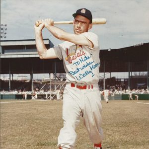 White man with cap swinging a bat in crowded stadium signed "To Mike Best Wishes Wally Moon"