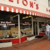 "Walton's" store with red and white awning and "Wal-Mart visitors center" on the windows