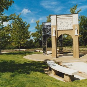 Park, pathway, and arch with trees in background