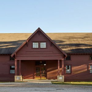 Multistory building with covered porch and double doors