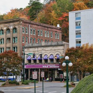 City street with tall buildings and two-story "wax museum"