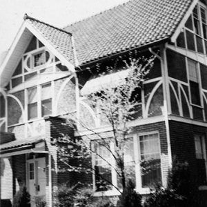 Multistory house with children playing in front yard