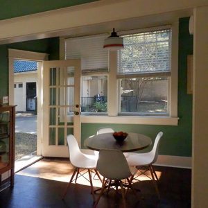 Interior of room with chairs round table and cabinet