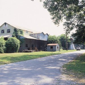 Abandoned multistory gin building and shed on street