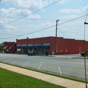 Brick storefront buildings on two-lane town street